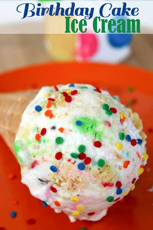 birthday cake ice cream with sprinkles in an ice cream cone laying down on a plate. 