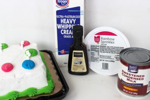 ingredients including a can of sweetened condensed milk, whipping cream, sprinkles, and vanilla extract. 