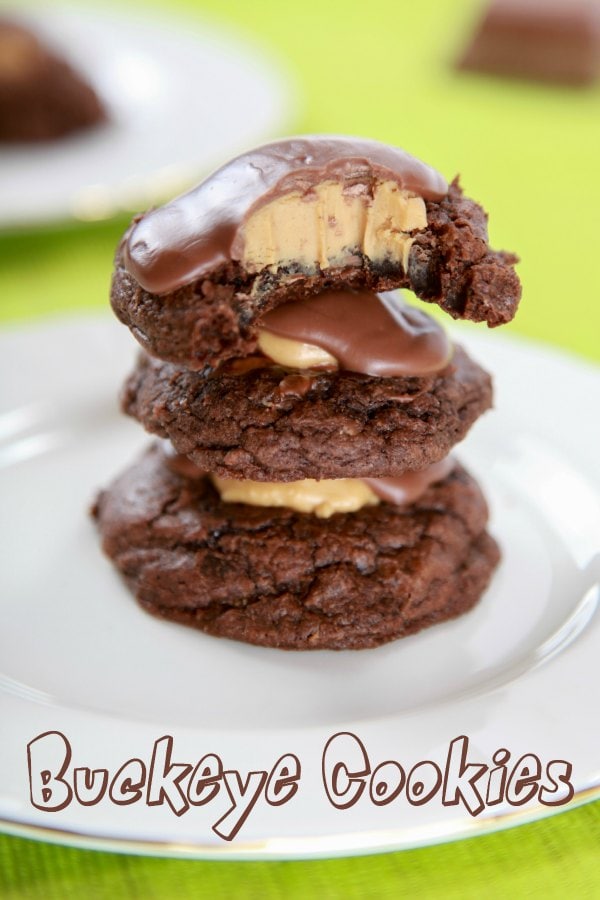 three brownie cookies stacked on top of each other and topped with peanut butter and chocolate 