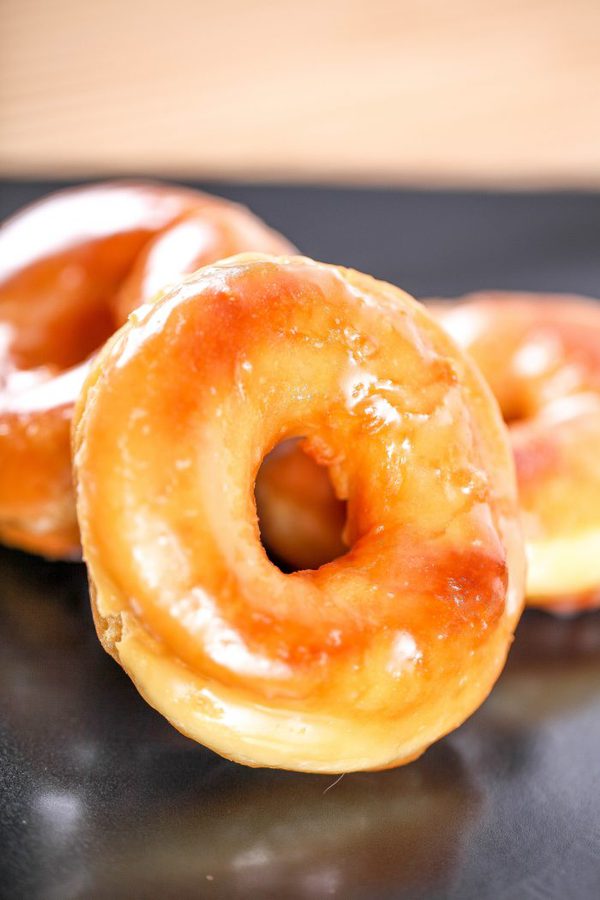 a copycat glazed krispy kreme doughnut with 2 more doughnuts in the background.