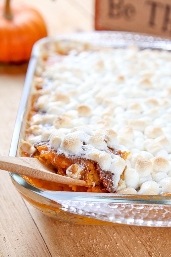 sweet potato casserole topped with pecans and marshmallows. 