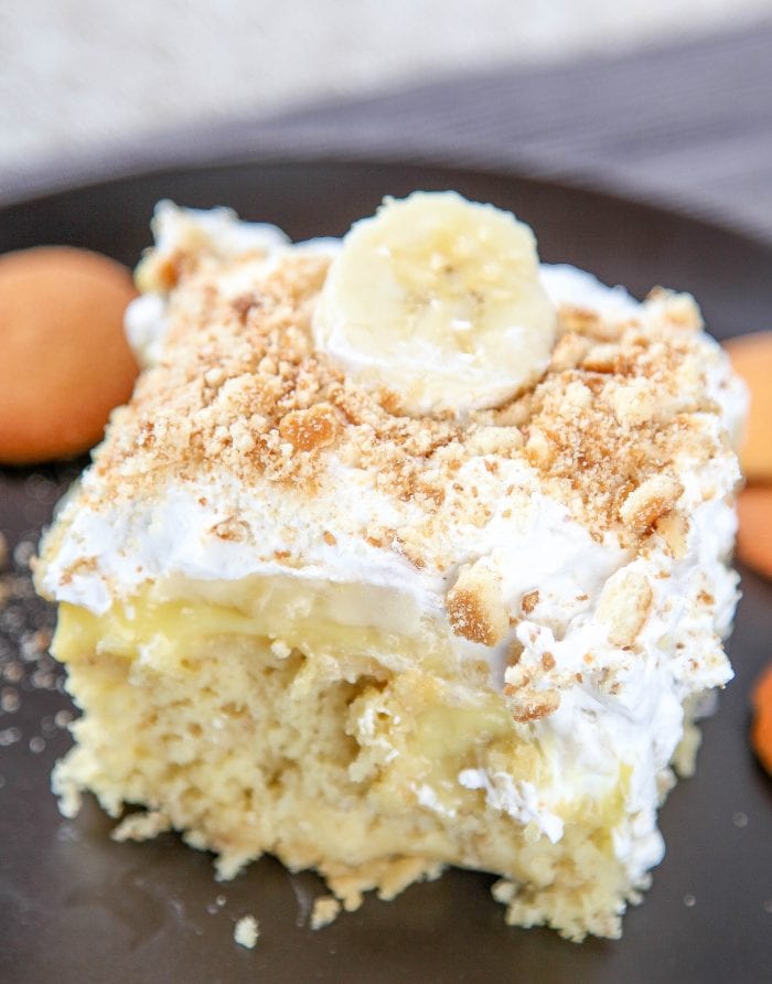 banana cake filled with banana pudding and topped with cool whip and crushed vanilla wafers. 