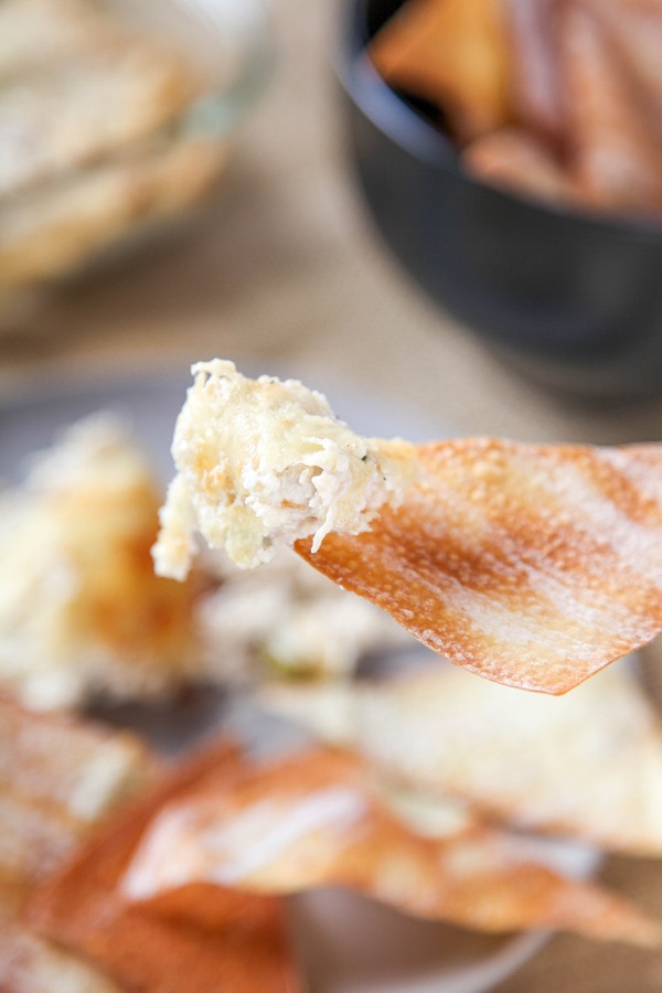 Crab Rangoon Dip with white cheddar cheese on a wonton chip.