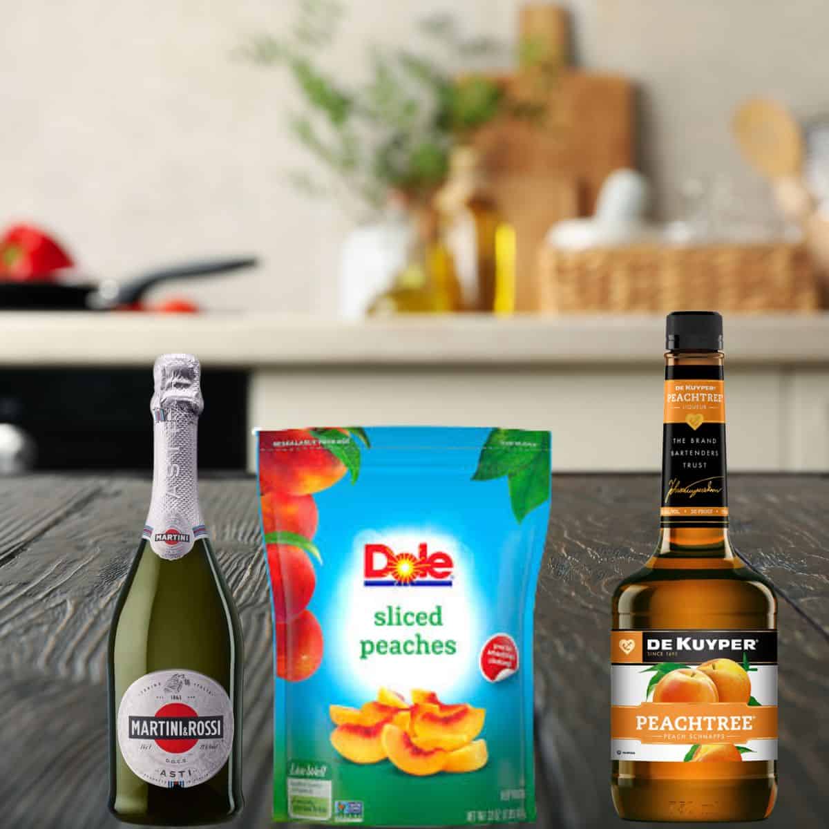 asti sparkling wine, frozen sliced peaches, and dekuyper peach schnapps on a wooden kitchen counter. 