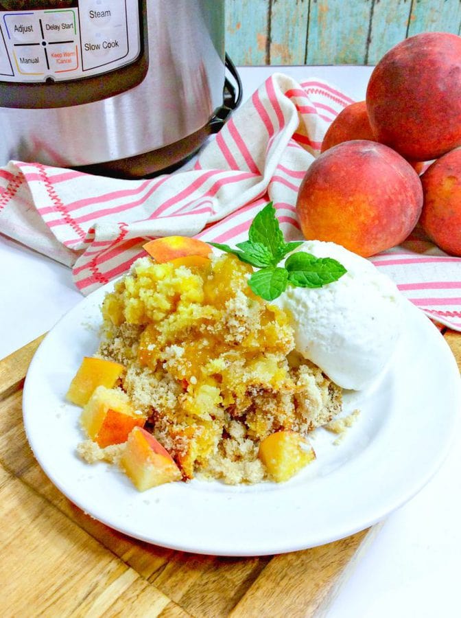 peach dump cake topped with peaches vanilla ice cream and fresh mint.