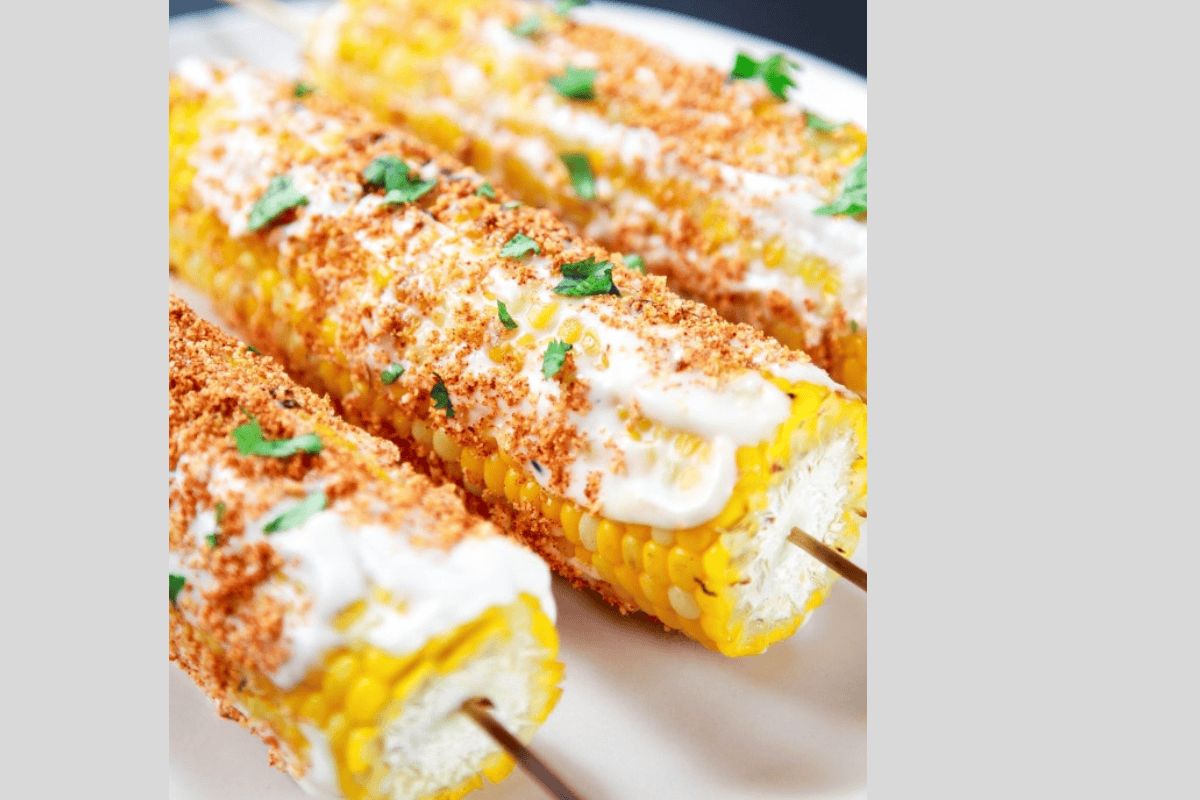 Corn on the cob topped with mexican spices and cilantro.