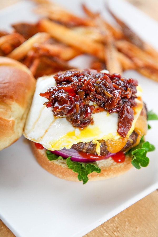 a burger topped with cheese, a fried egg, and bacon jam. 