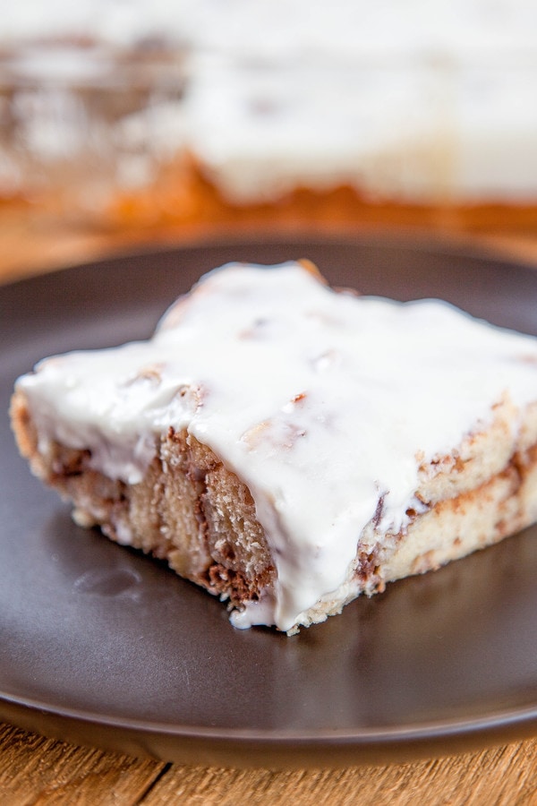 cinnamon roll french toast casserole topped with cream cheese icing.