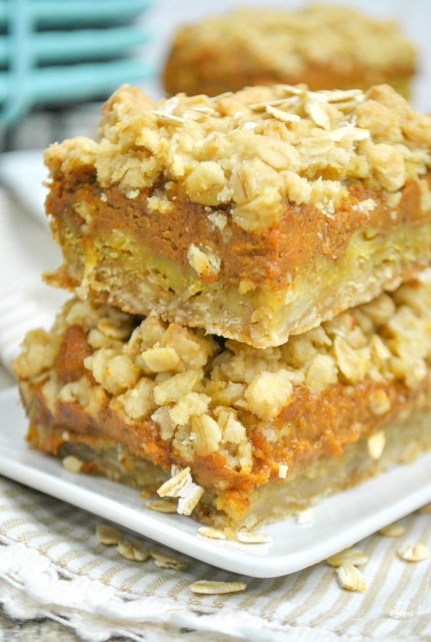 a closeup of two pumpkin pie bars with an oat crust and topping.