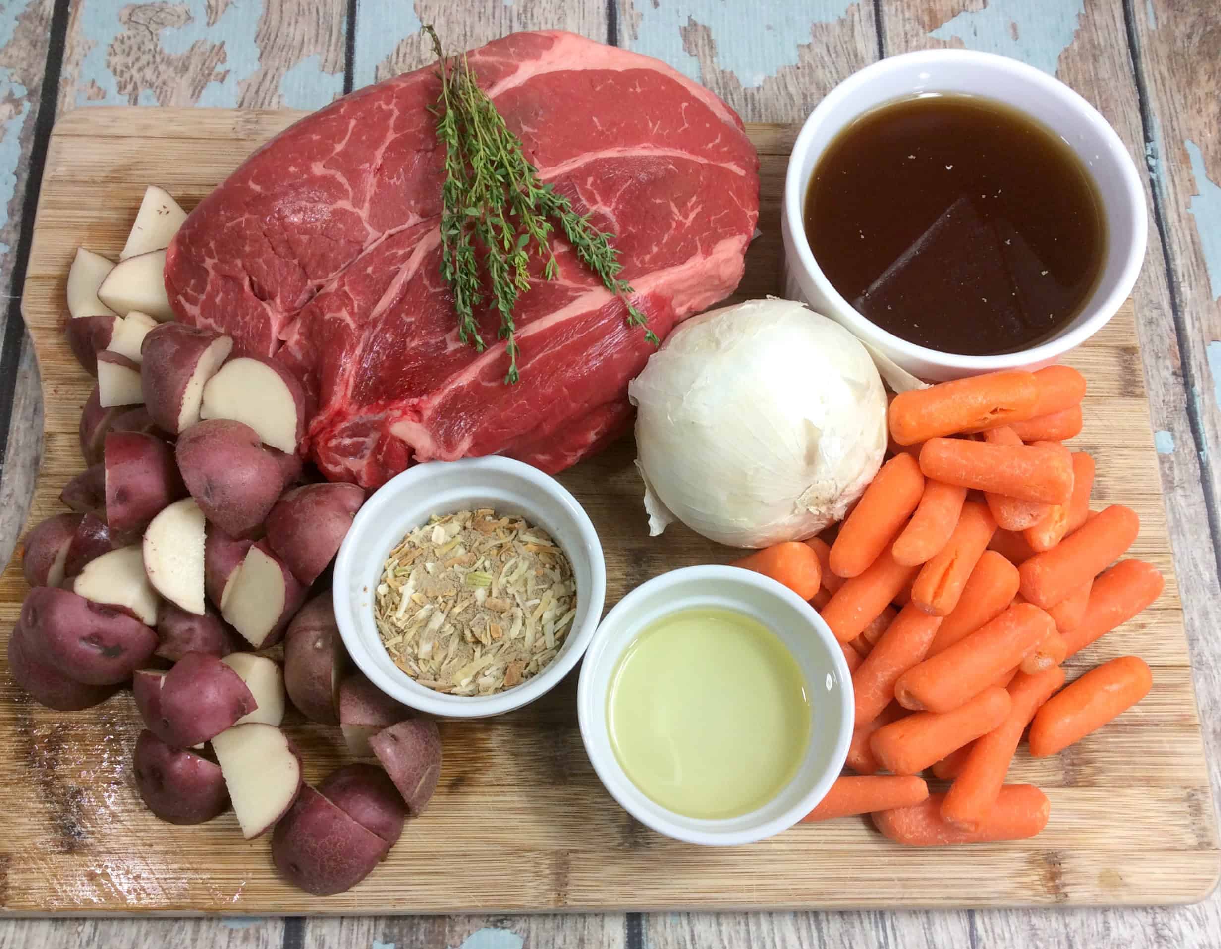 ingredients including beef chuck roast, red potatoes, carrots, beef broth, onion, and onion soup mix.