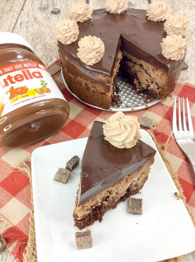 a slice of nutella cheesecake with a whole cheesecake and a jar of nutella in the background.