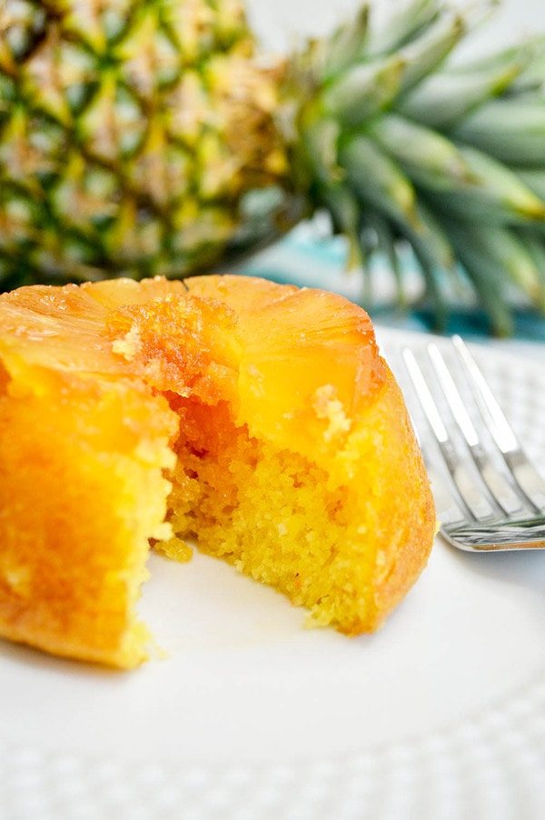 a mini pineapple upside down cake cut in half and topped with pineapple.