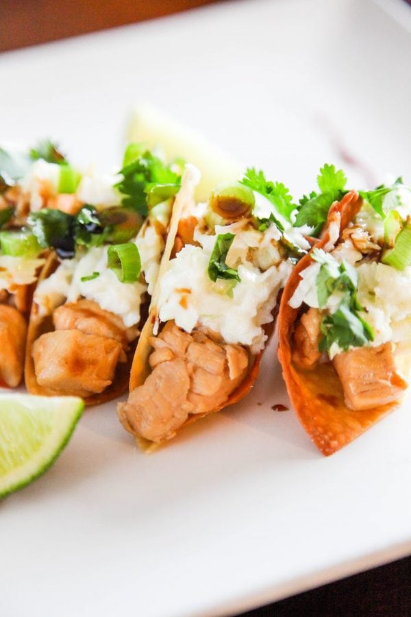 wonton tacos filled with chicken and topped with coleslaw and cilantro.  