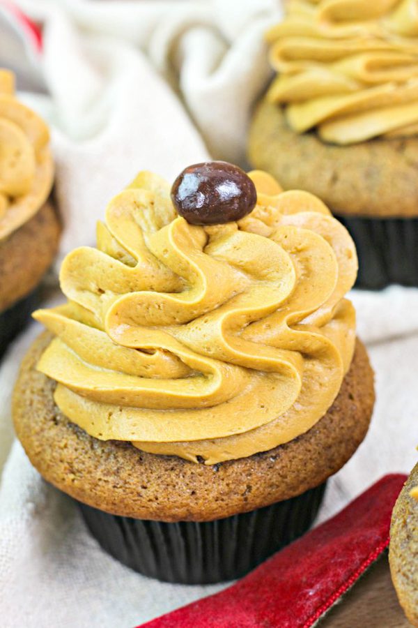 a closeup view of instant coffee cupcakes topped with espresso frosting and an espresso bean.