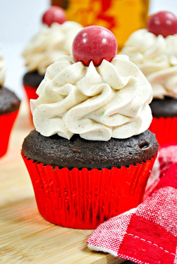 a closeup of a chocolate cupcake topped with piped fireball frosting.