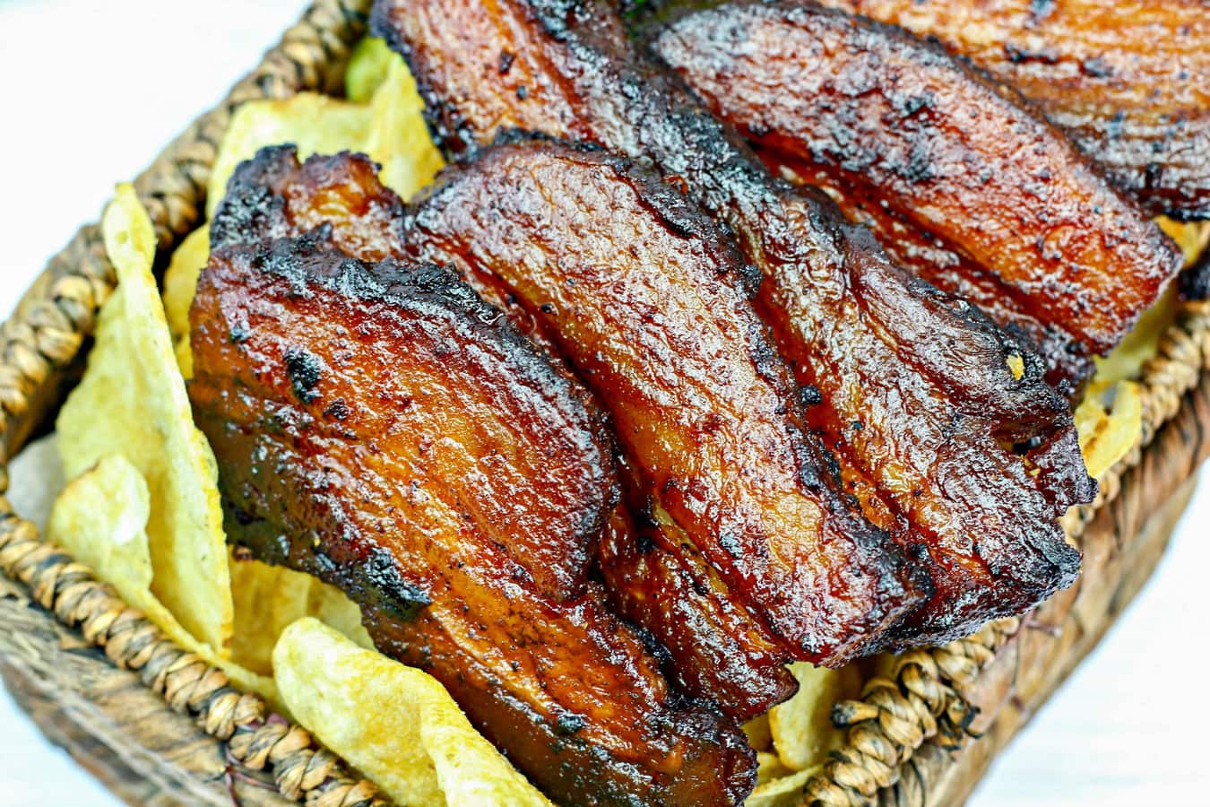 a basket of pork belly burnt ends and potato chips.