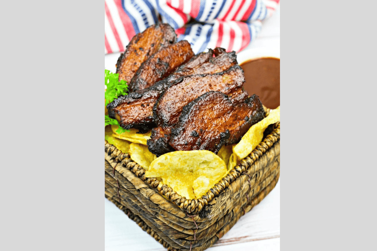 a basket of pork belly burnt ends and potato chips.