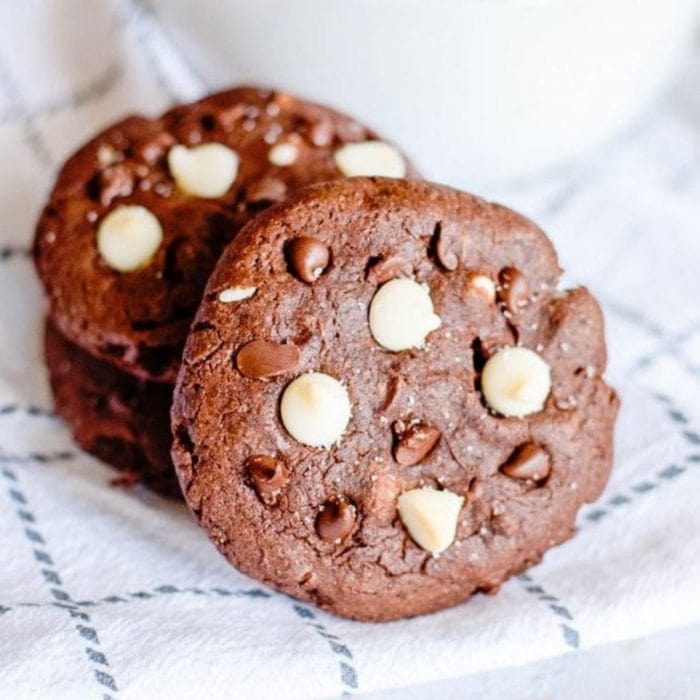 a stack of coffee cookies with chocolate chips on a dish towel.