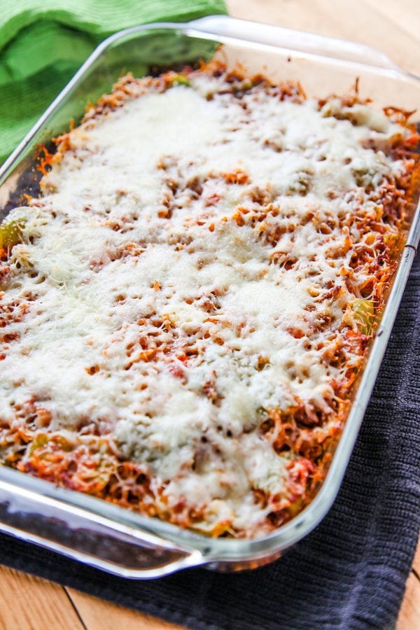 a glass 9 x13 inch dish filled with stuffed pepper casserole and topped with mozzarella cheese.