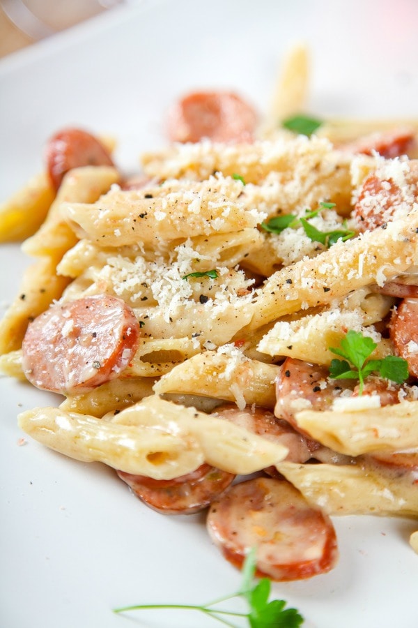 penne pasta in a sun dried tomato cream sauce with sausage coins and topped with parmesan cheese.