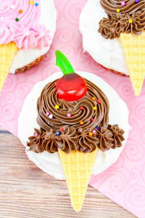 a cupcake decorated with chocolate butter cream and a cookie piece to resemble an ice cream cone.