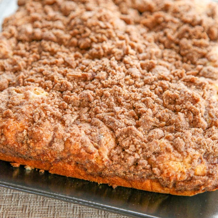 a close of shot of a whole coffee cake with crumb topping.