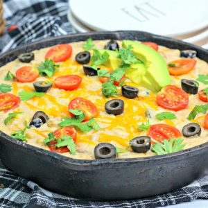 a close up shot on warm bean dip in a cast iron skillet.