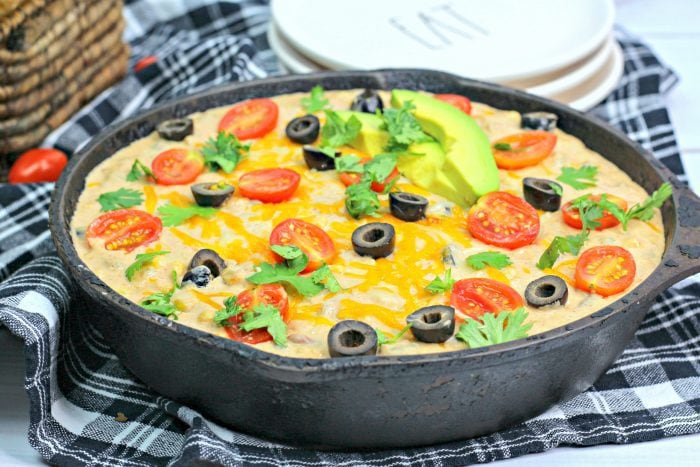 a close up shot on warm bean dip in a cast iron skillet.