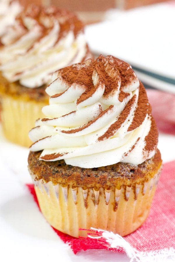 coffee soaked vanilla cupcakes topped with mascarpone frosting and cocoa powder.