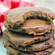 a chocolate cookie with chocolate icing on distressed wood.