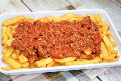 homemade french fries topped with chili with beef. 