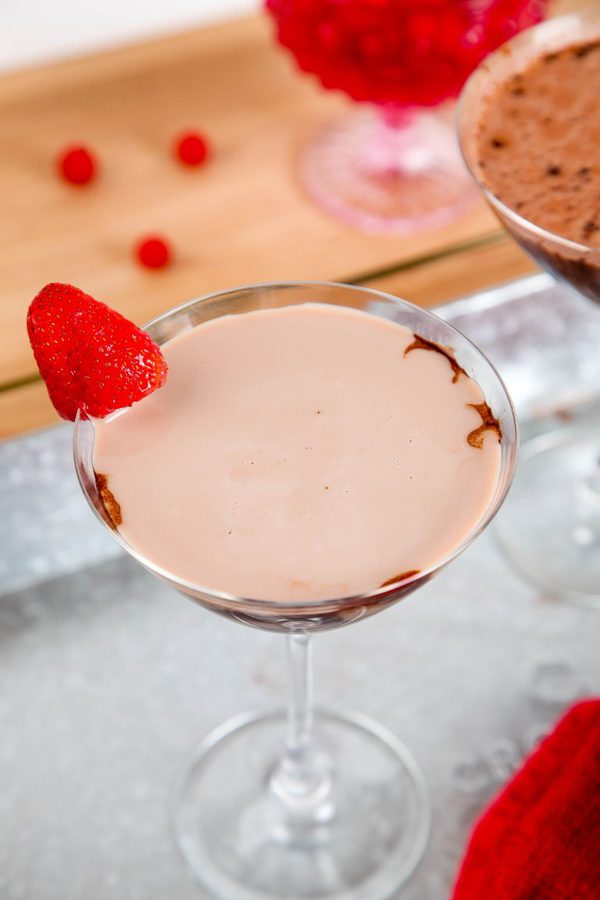 an overhead view of a chocolate martini garnished with a single strawberry.