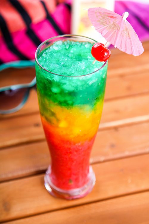 a bob marley drink garnished with an umbrella and a cherry. 