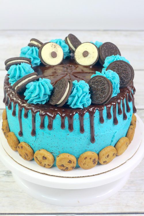 a cookie monster cake with blue oreo frosting and chocolate ganache.