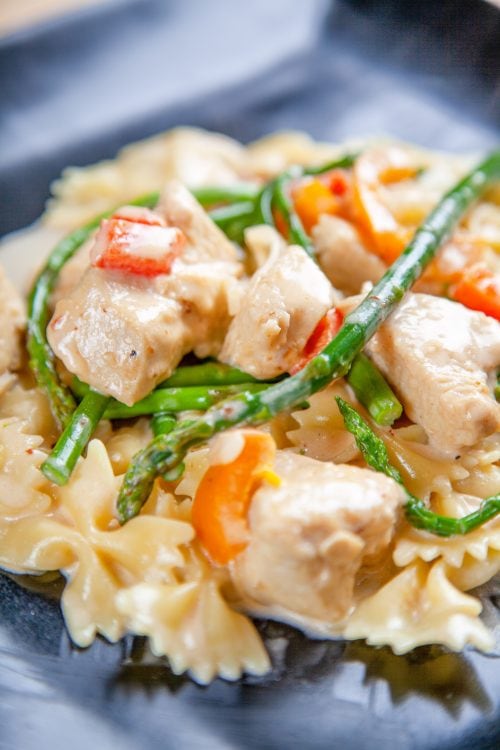 chipotle chicken, orange bell pepper, and asparagus in a cream sauce.