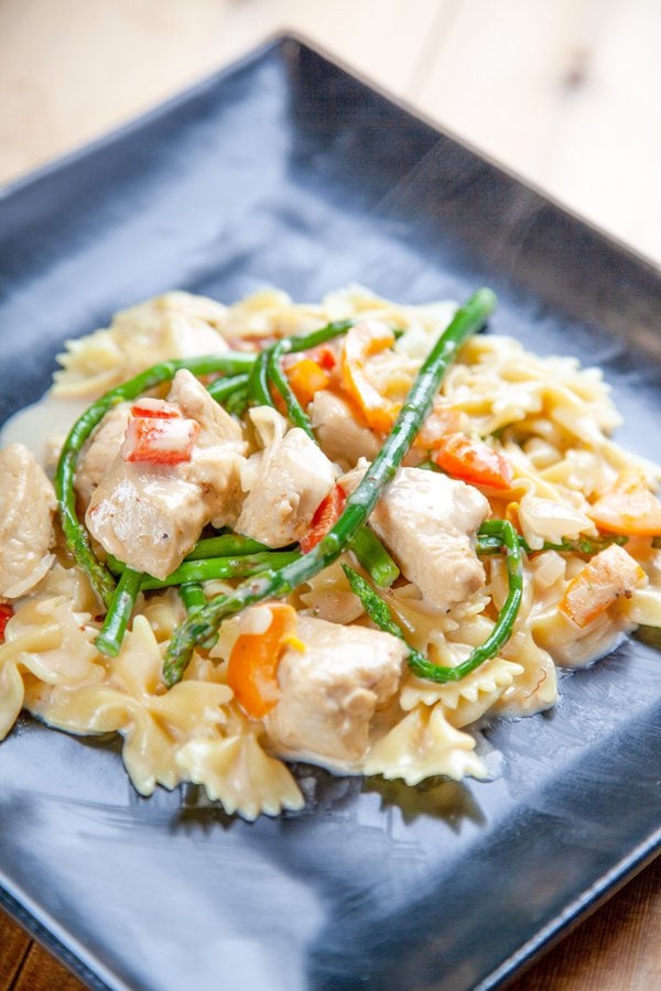 pasta with chicken, bell peppers, asparagus, and farfalle noodles.