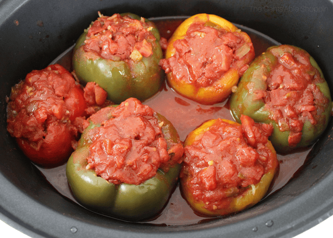 tomato stuffed bell peppers in a black slow cooker 