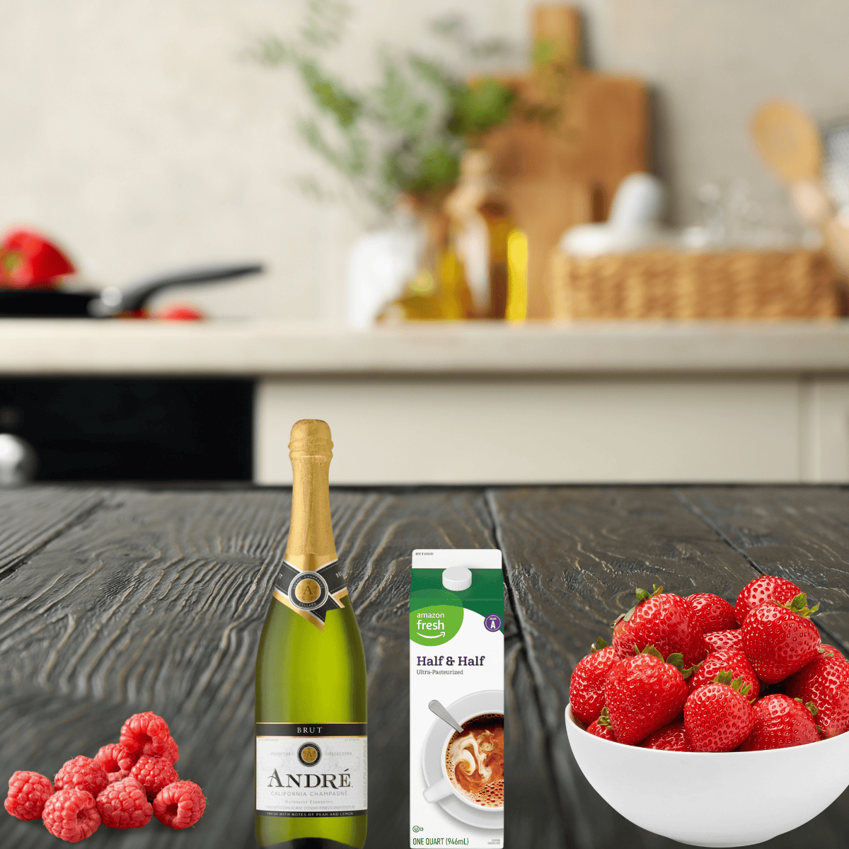 strawberries, raspberries, champagne and half and half on a counter. 