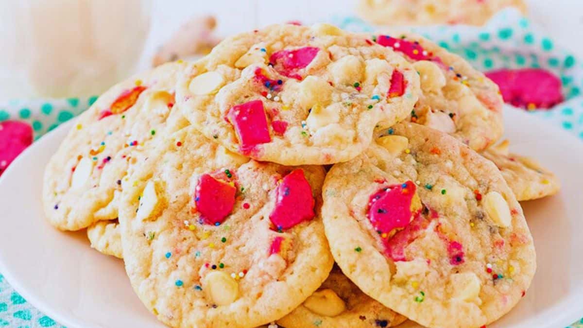 a plate of soft and chewy cookies with animal crackers mixed in.