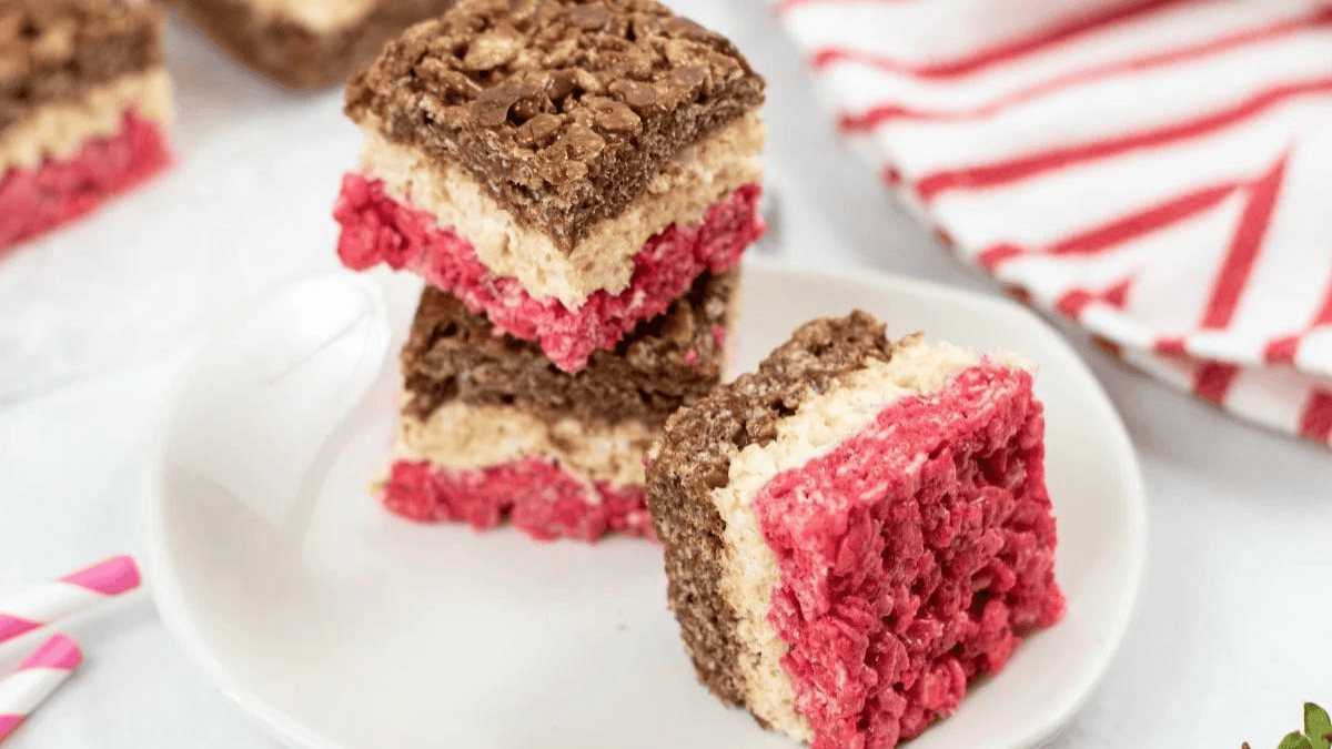 A plate of rice krispie squares with neapolitan colors and flavors.