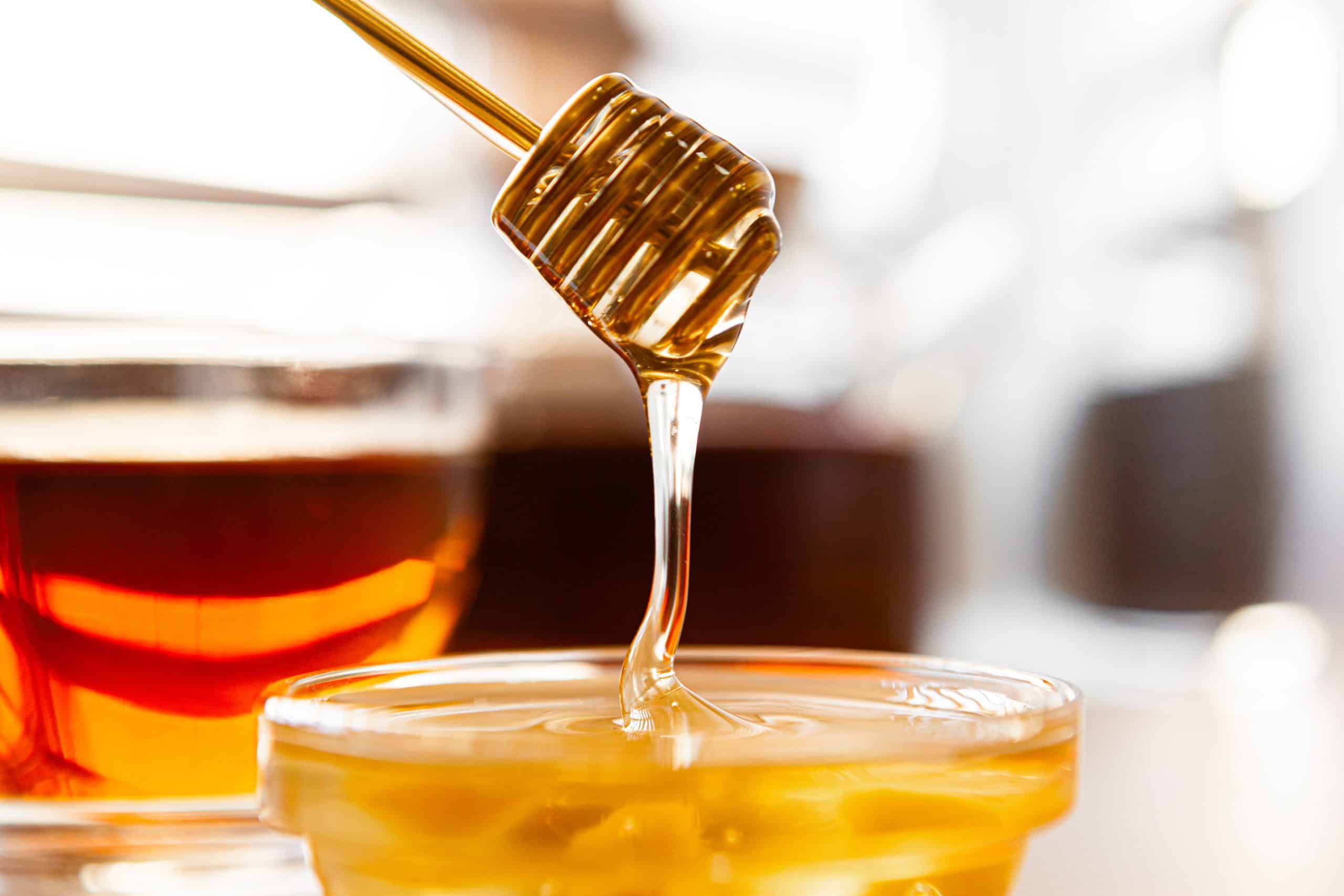 Close up of glass tea cup with honey