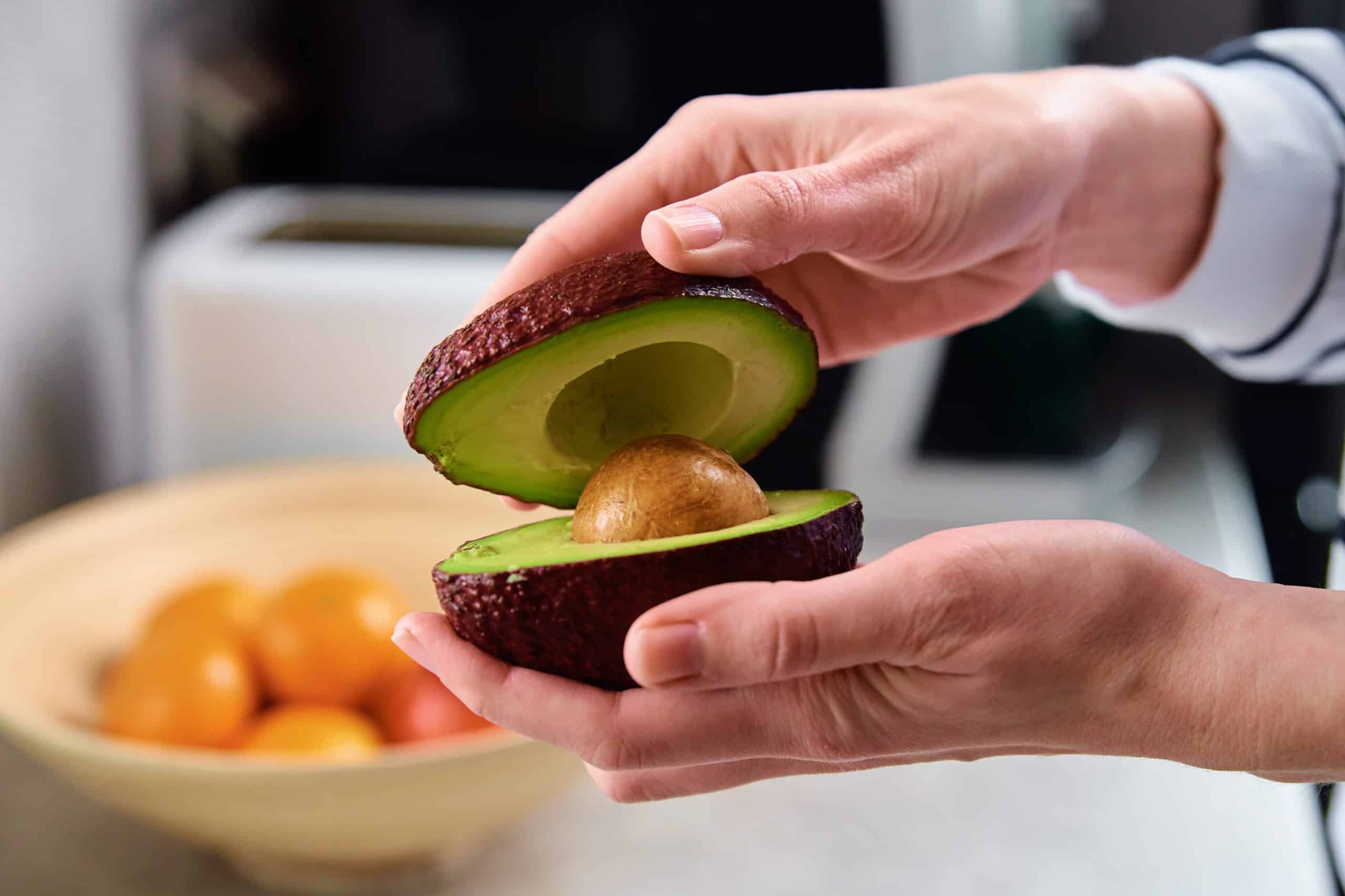 Woman hold fresh ripe avocado, Healthy food and dieting concept, Organic product