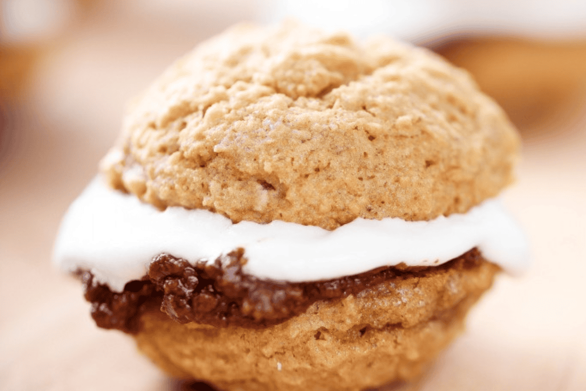 Delicious smores whoopie pies with marshmallow buttercream and milk chocolate filling.