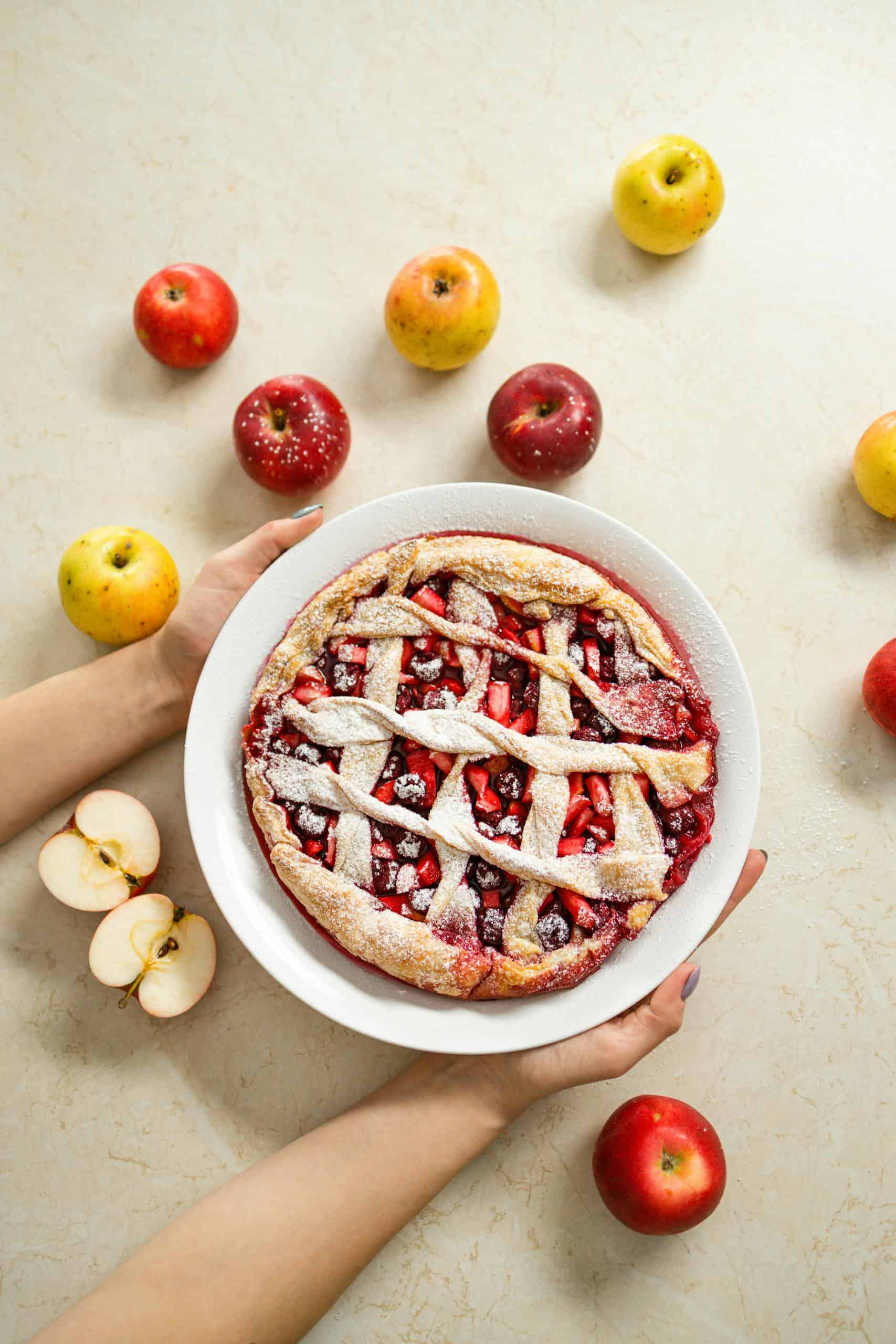 Homemade apple pie with fresh apples, captured from above, perfect for bakery themes.
