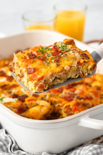 Serving of bacon,egg and cheese bake on spatula.