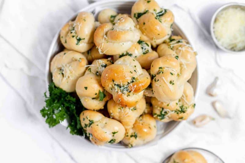 A pile of bread rolls on a plate.