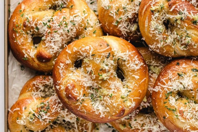 Garlic parmesan pretzels stacked overlapping on top of each other.