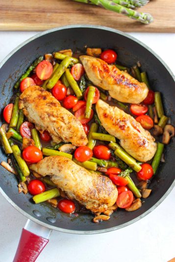 One pan chicken and asparagus in a pan.