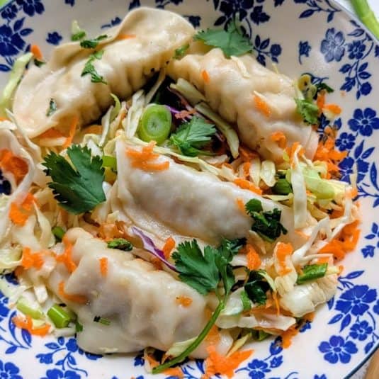 Vegan pot sticker salad recipe gluten free gyoza salad with asian dumplings 15 minute filling salads for lunch or dinner plant based recipes with dumplings.