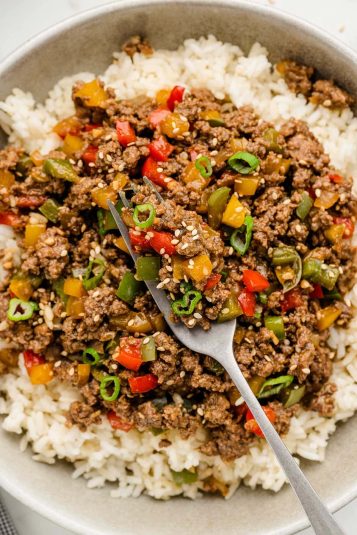 Serving Beef and Pepper Rice Bowl in a large bowl with a fork.